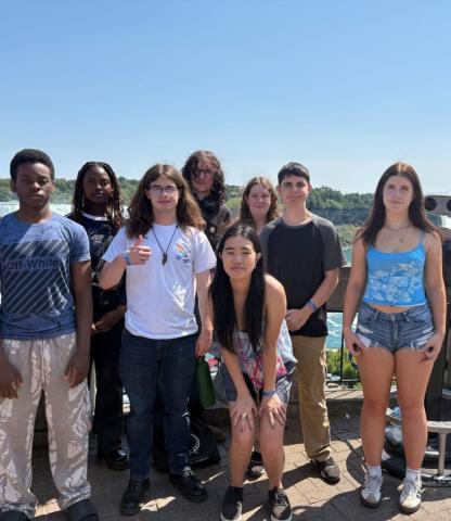 A group of youths post outside