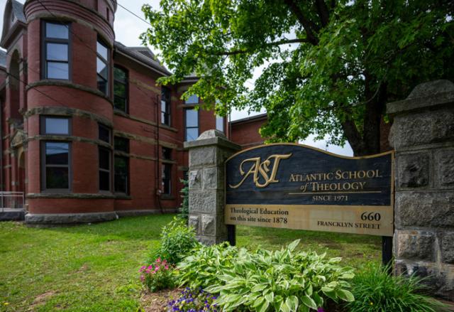 A sign in front of a building that says "Atlantic School of Theology"