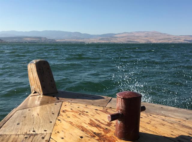 A picture of a wooden dock on the blue waters of the Sea of Galilee.