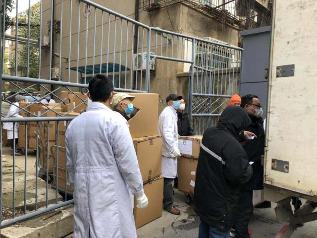 Photo of people unloading medical supplies from trucks in Wuhan, China