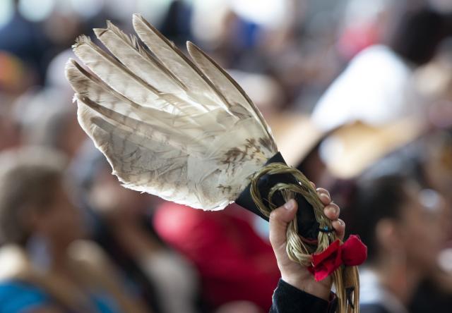 Photo of an eagle feather held up during ceremonies marking the release of the Missing and Murdered Indigenous Women report in Gatineau, June 3, 2019