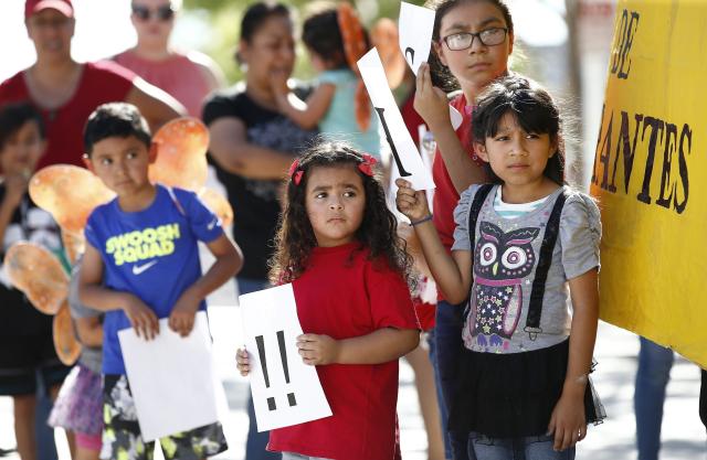 Children at an immigration family separation protest in Phoenix, AZ, June 18, 2018. Children holding protest signs