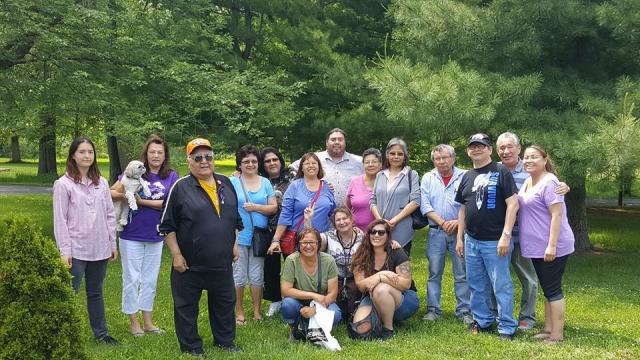 A group photo of members of the Naandwindizwin-Wechihitita Residential School Survivors Support Group together in a park.