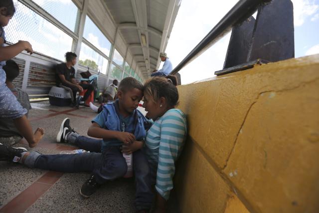 A migrant mother and child share a moment after camping out on the Gateway International Bridge leading from Mexico into Brownsville, TX. Migrant mother and child