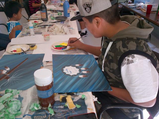 Child painting in the Neechi program
