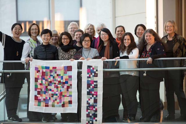 A delegation of women went to Vancouver to call for peace in Korea. Here the group displays a peace banner made of the event.