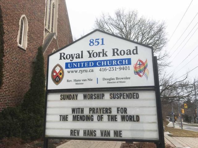 A church sign outside Royal York United Church says "Church Suspended, with Prayers for Mending of the World."