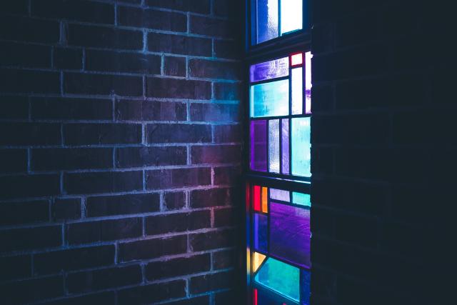 Stained glass beside brick wall