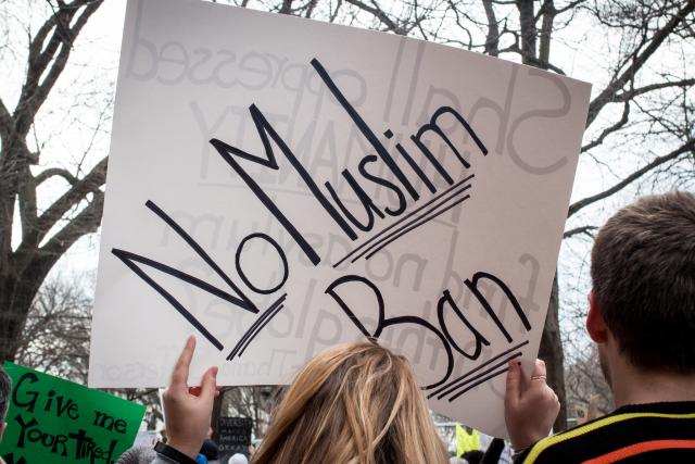 Sign being held aloft: No Muslim Ban