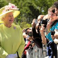 Queen Elizabeth greets onlookers at an event