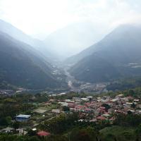 A small mountain village, with one main street, seen from an aerial view.