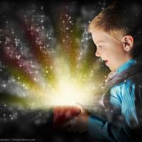 A boy smiles as he opens a gift