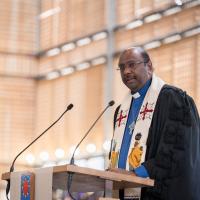 A photo of Rev. Prof. Dr. Jerry Pillay speaking at a lectern.