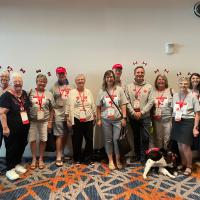 A group of individuals in a boardroom, many wearing Canadian flag headbands.
