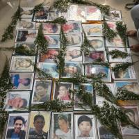 Several framed photos of Filipino youth surrounded by bouquets of flowers.