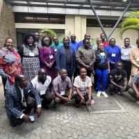 A group of African clergy and lay people outside of a building