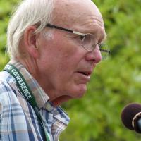 The Very Rev. Dr. Robert F. Smith speaking into a microphone