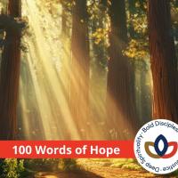 A ray of light in a forest, with a banner over top reading "100 words of hope"