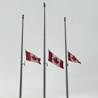 Three Canadian flags at half-mast