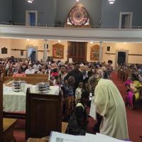 A group of children being baptised in a church