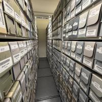 Rows of labelled archival boxes