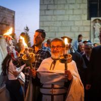 An easter procession outdoors attended by Palestinians